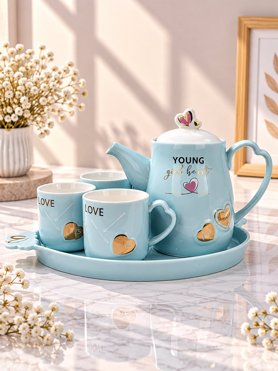 Blue ceramic teapot set with four cups and matching serving tray featuring LOVE